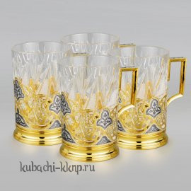 Набор из четырех серебряных подстаканников с позолотой 